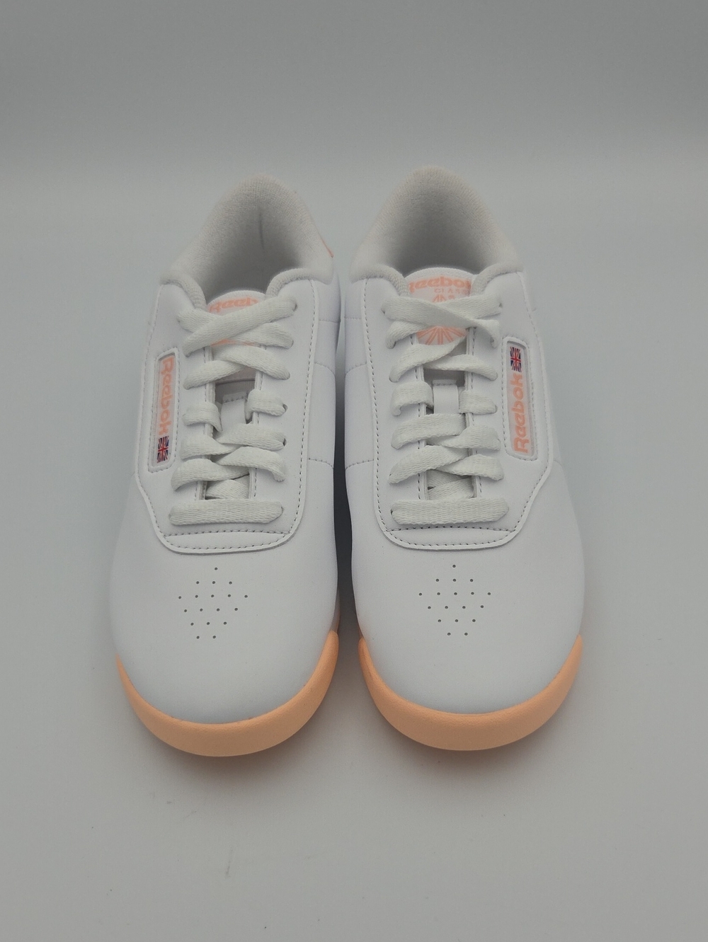 Reebok Women’s White Sneakers with Peach Accent